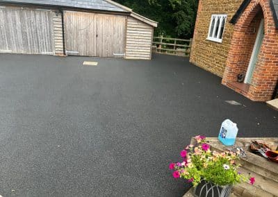 A completed black resin bound driveway at a period property in the Bedfordshire countryside