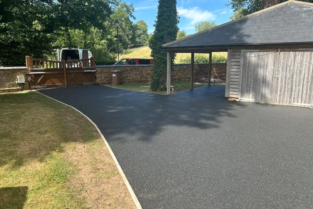A black resin bound driveway at a period property in the Bedfordshire countryside