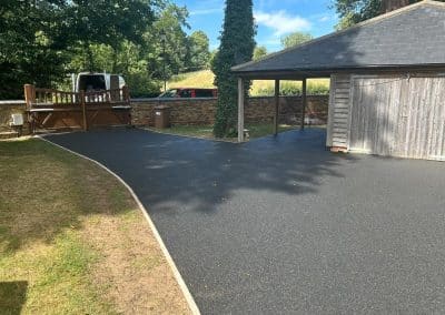 A black resin bound driveway at a period property in the Bedfordshire countryside