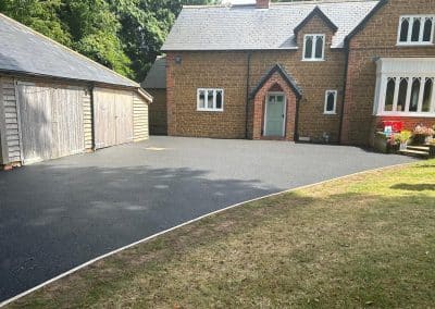 A black resin bound driveway at a period property in the Bedfordshire countryside
