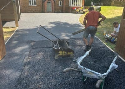 Contractors installing black resin bound driveway at a period property in the Bedfordshire countryside