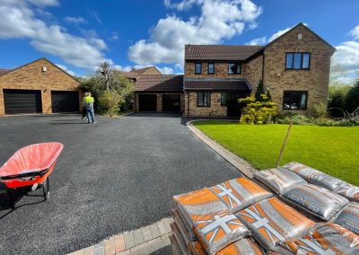 House with tarmac substrate on driveway and resin materials prior to application