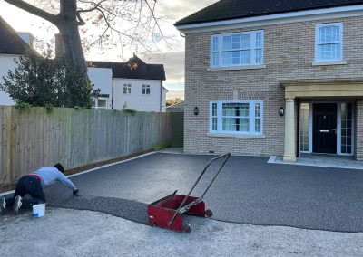 Workers applying resin driveway surface