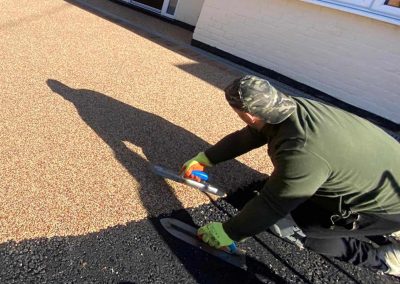 Workers applying resin driveway surface
