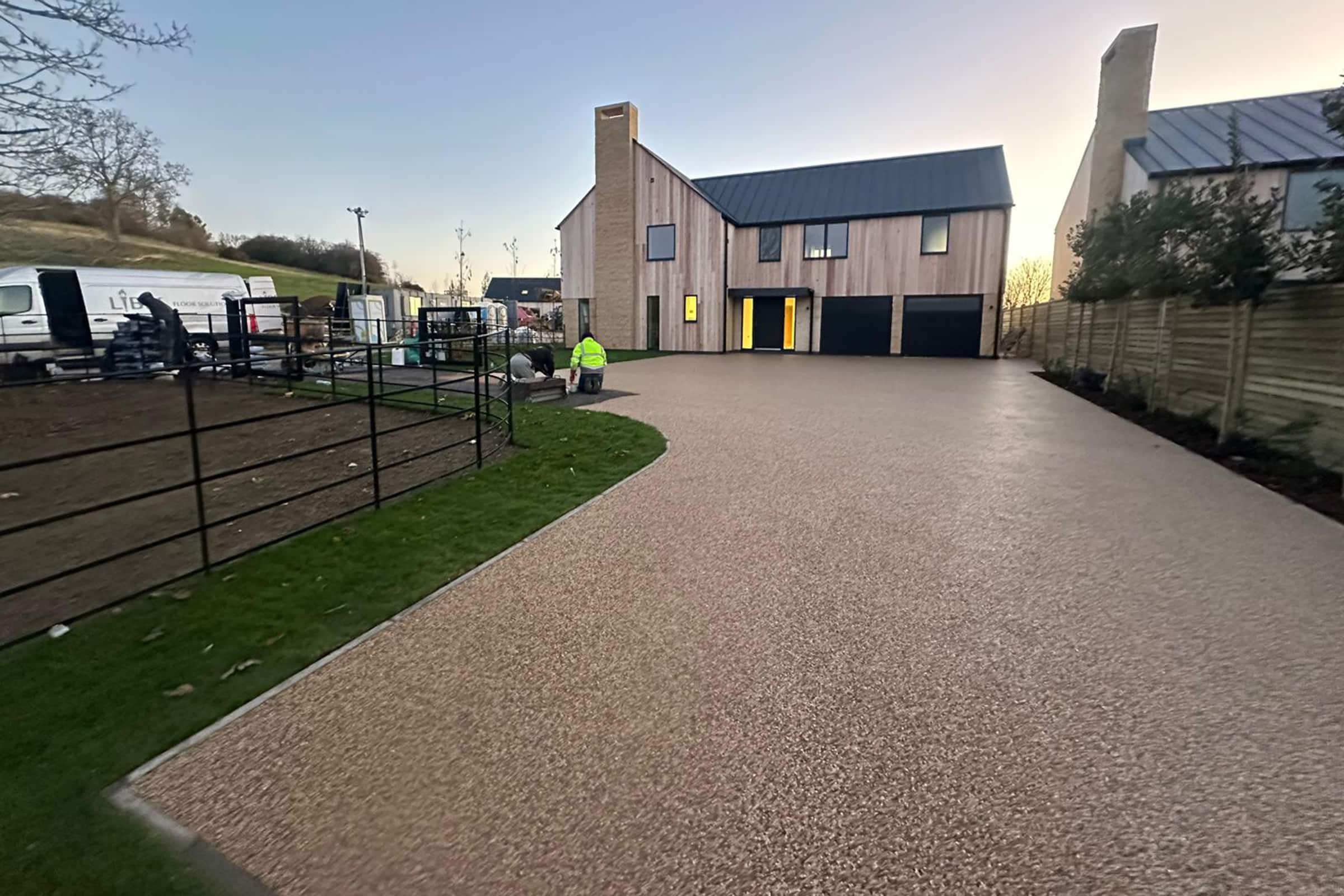 Workers installing resin bound driveway