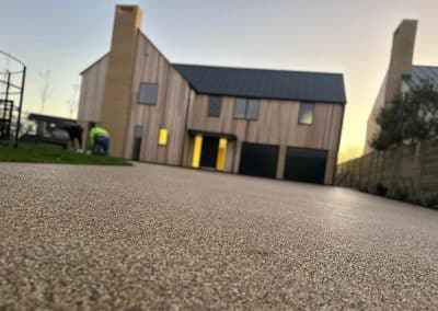 Workers installing resin bound driveway