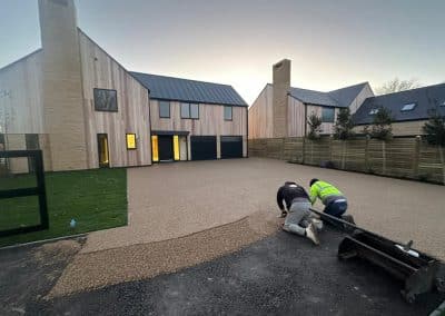 Workers installing resin bound driveway