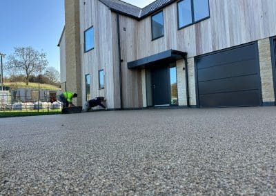Workers applying resin driveway surface