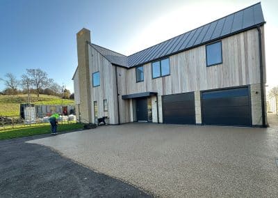 Workers applying resin driveway surface