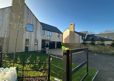 Worker applying resin driveway surface