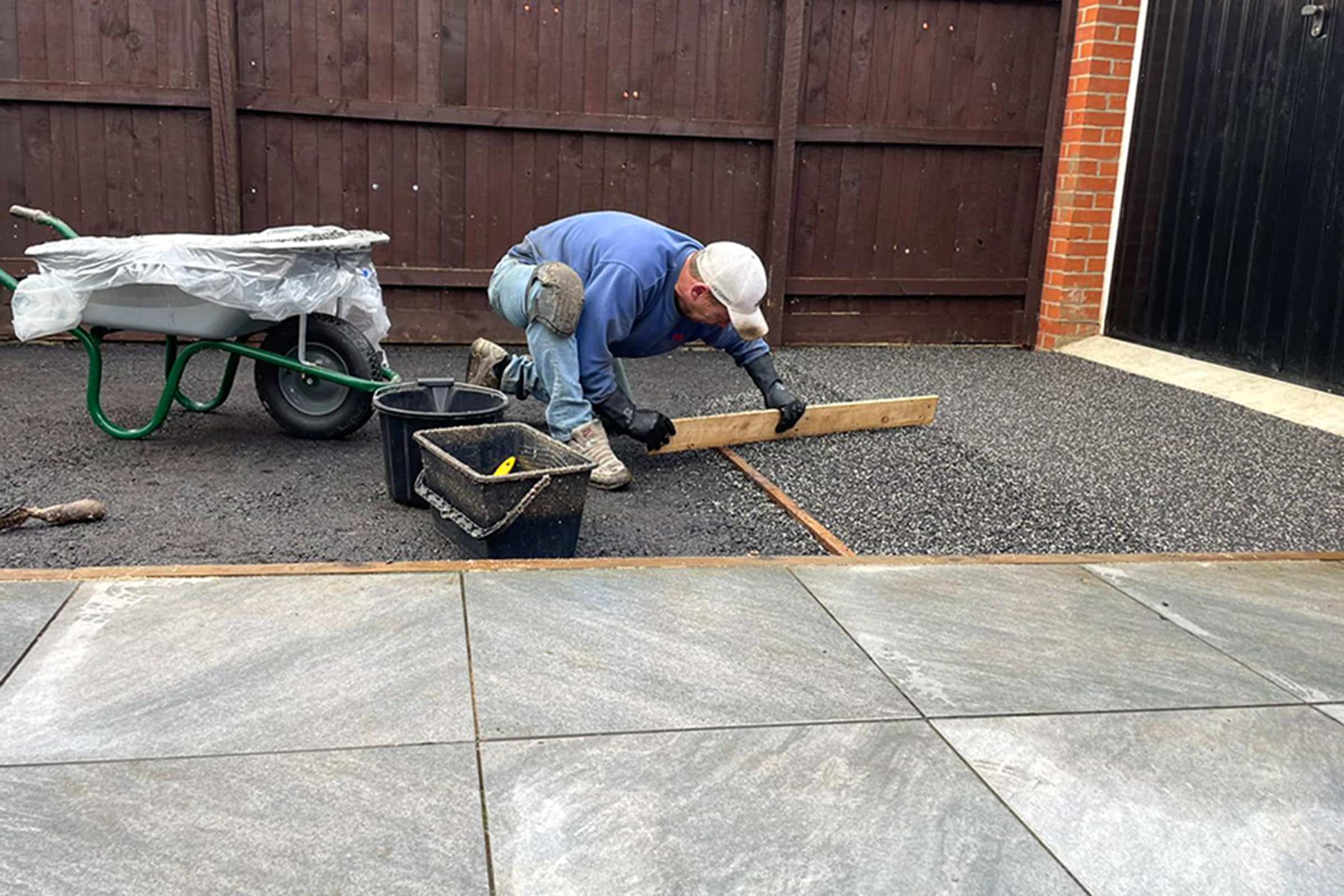 Workers applying resin driveway surface