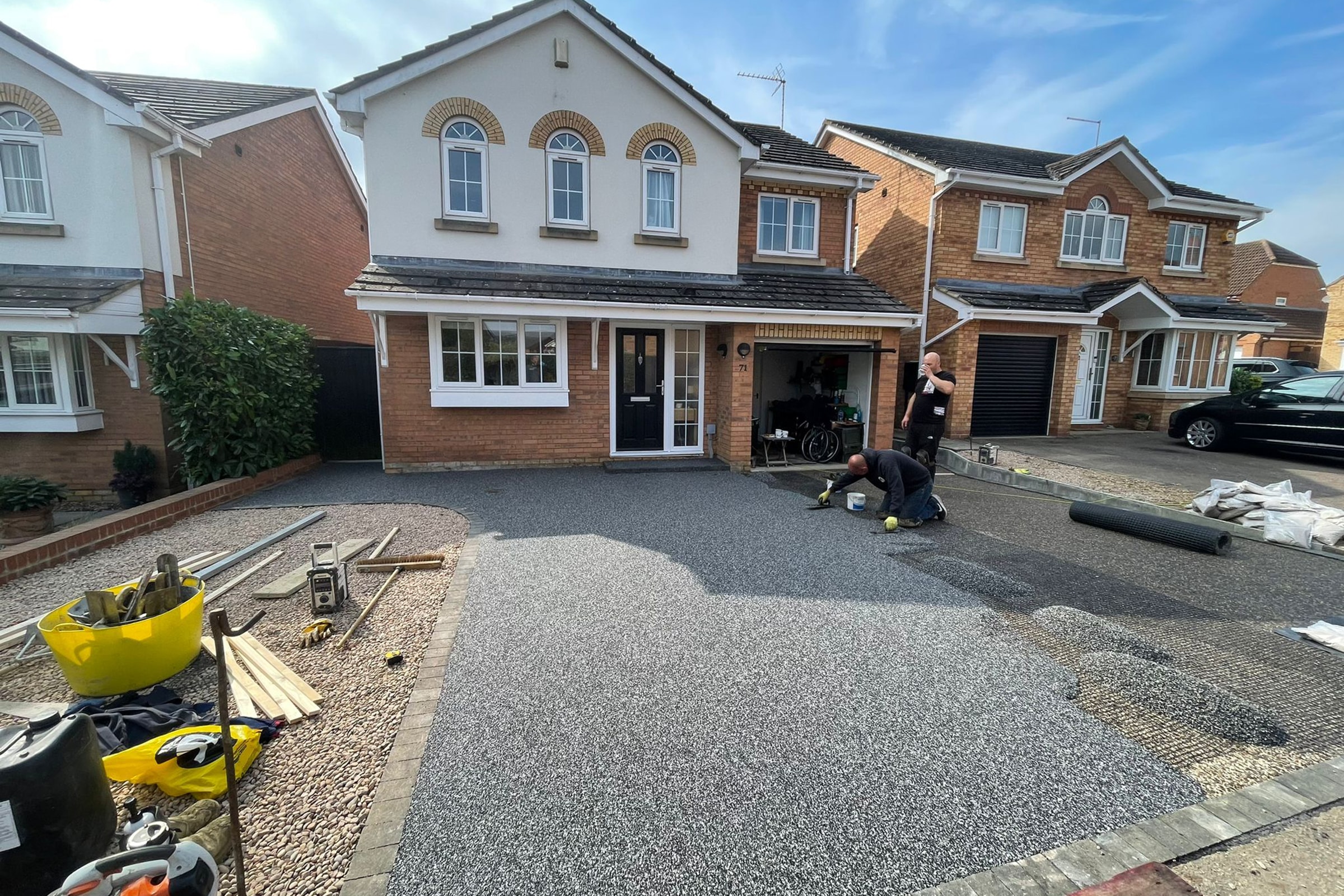 Resin bound driveway in Rushden, Northamptonshire Workers applying resin driveway surface