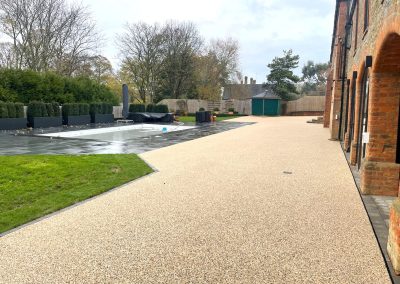 Resin bound driveway with landscaped surroundings.