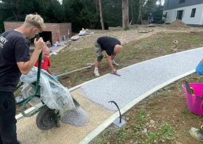 Workers constructing a resin pathway.
