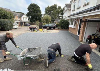 Workers applying resin driveway surface