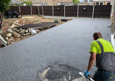 Worker applying resin bound surface material