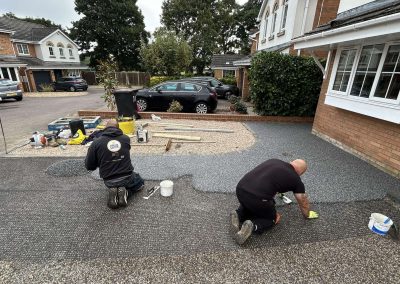 Workers applying resin driveway surface