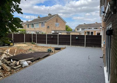 Resin bound surface in backyard with construction debris