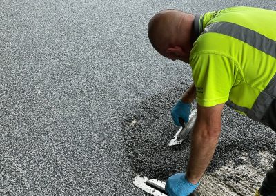 Worker applying resin bound surface material