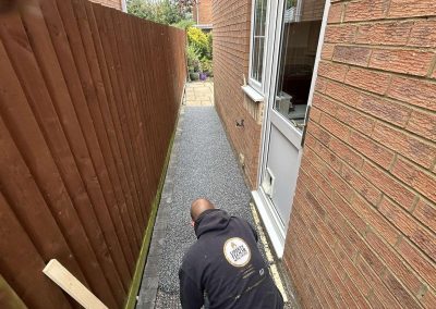 Workers applying resin driveway surface to pathway