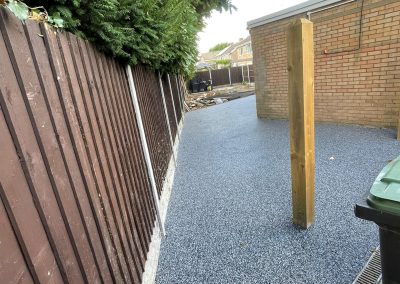 Resin bound pathway beside wooden fence