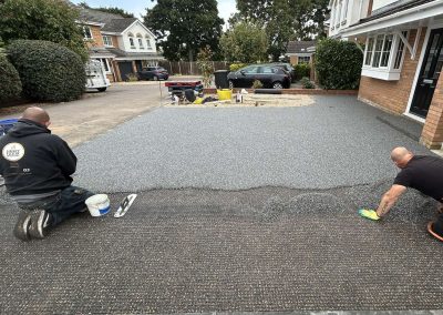 Workers applying resin driveway surface