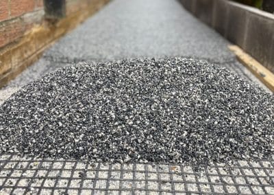 Close-up of dark grey resin bound surface with underlay mesh