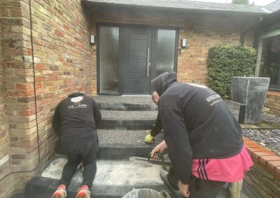 Workers installing resin bound steps at entrance